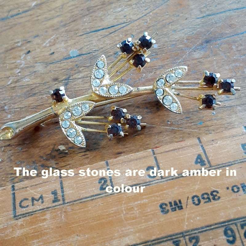 Gilt metal brooch with amber and clear glass stones.  Floral vintage