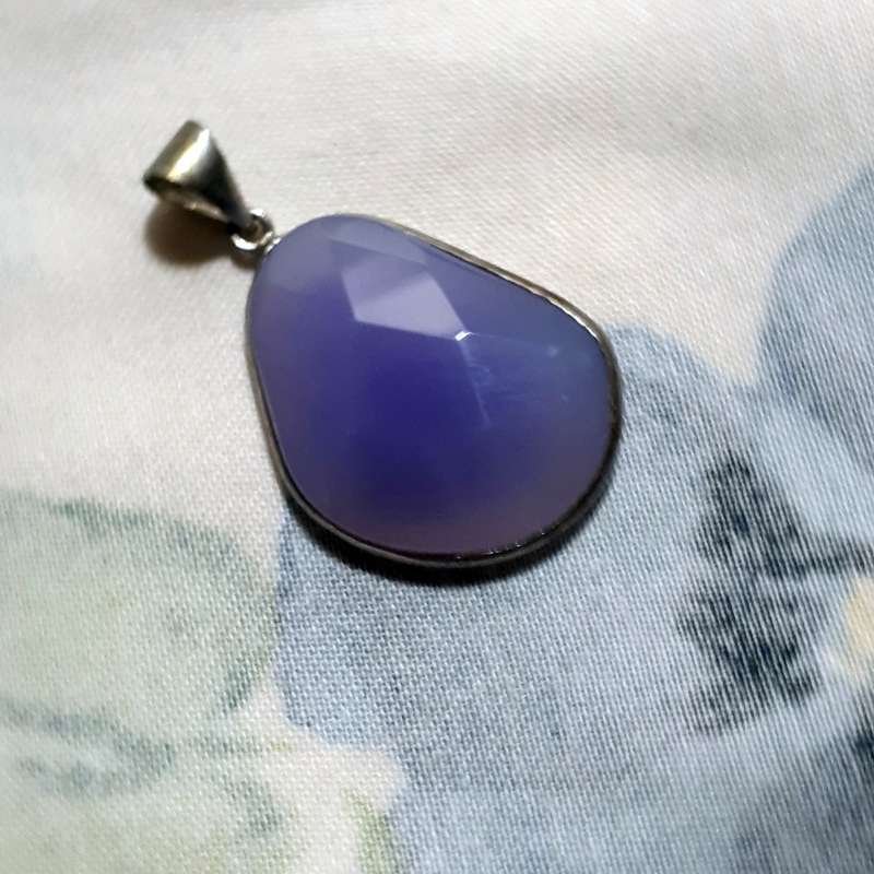 Pendant - faceted purple lilac stone in silver metal surround.