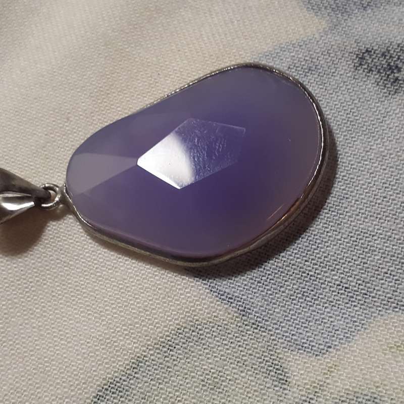Pendant - faceted purple lilac stone in silver metal surround.