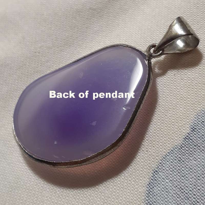Pendant - faceted purple lilac stone in silver metal surround.