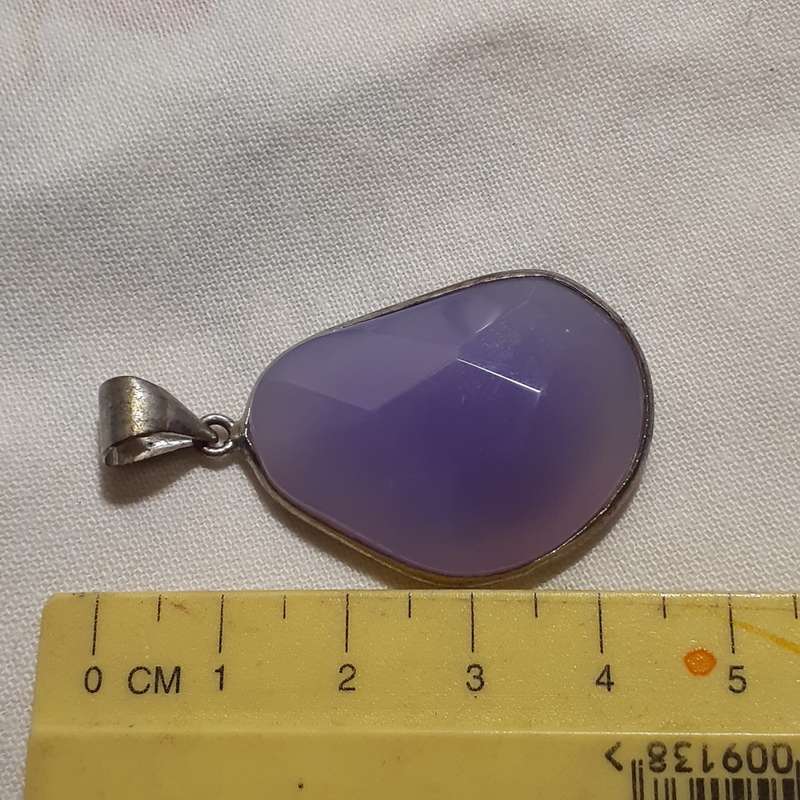 Pendant - faceted purple lilac stone in silver metal surround.