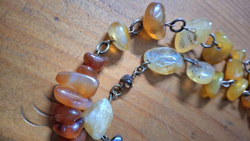 Polished orange agate necklace on heavy chain.