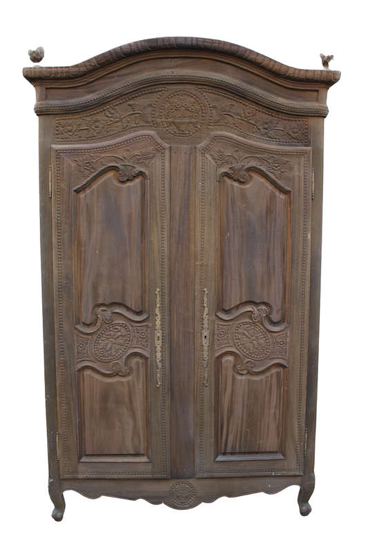 A 20th Century French Style Armoire in a  Carved Wood and in a Natural Wood Finish