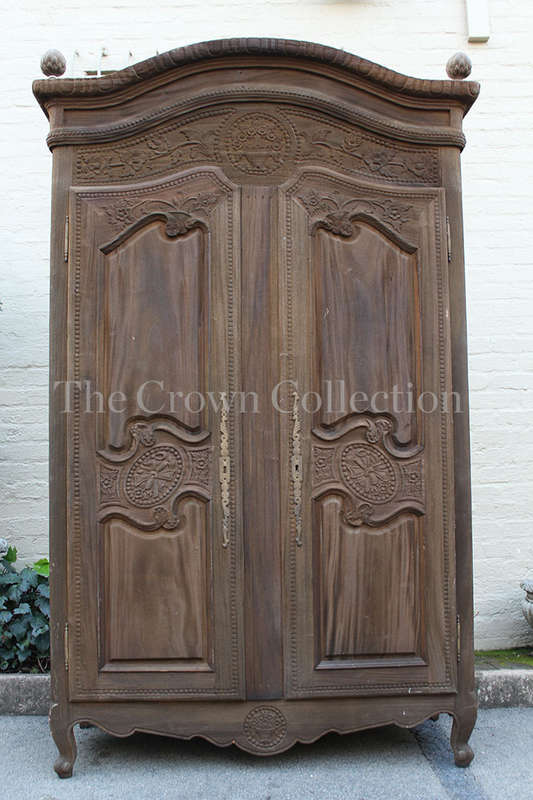 A 20th Century French Style Armoire in a  Carved Wood and in a Natural Wood Finish