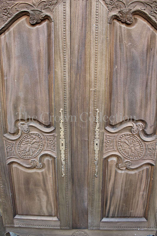 A 20th Century French Style Armoire in a  Carved Wood and in a Natural Wood Finish