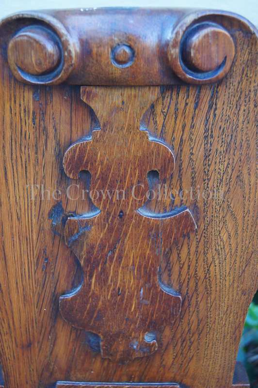 A Late Vicrian Oak Hall chair with with burbon stile on scrolled ear on back rest and a scrolled ...