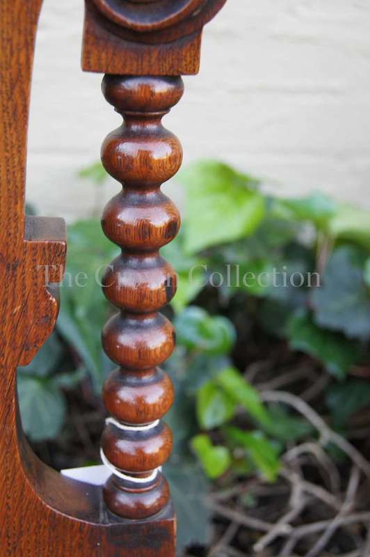 A Late Vicrian Oak Hall chair with with burbon stile on scrolled ear on back rest and a scrolled ...