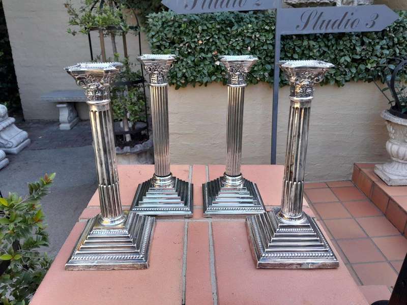 A Set of Four 20th Century Elizabeth II Silver-Plated Corinthian Column Candlesticks