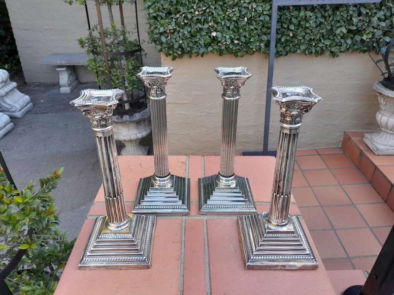 A Set of Four 20th Century Elizabeth II Silver-Plated Corinthian Column Candlesticks