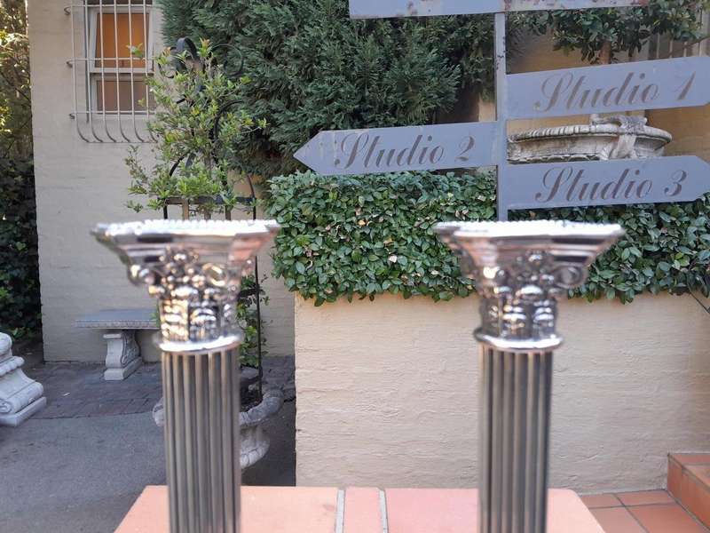 A Set of Four 20th Century Elizabeth II Silver-Plated Corinthian Column Candlesticks