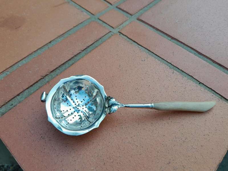 A Silver Tea Strainer with Bone Handle 38g weight