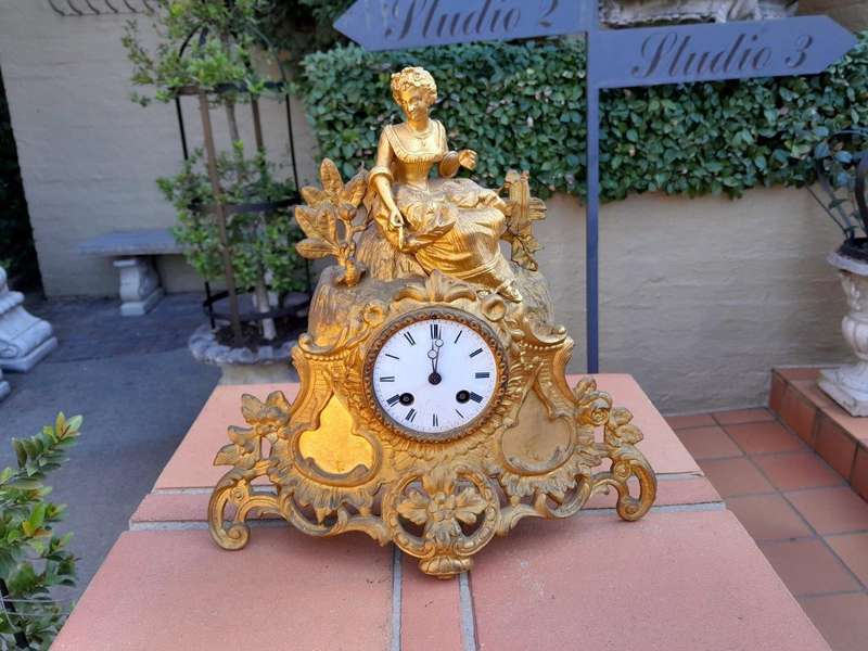 A 19th Century French Gilt Spelter Clock with Pendulum and Key