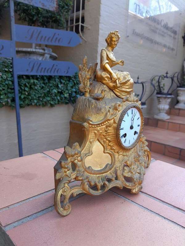 A 19th Century French Gilt Spelter Clock with Pendulum and Key