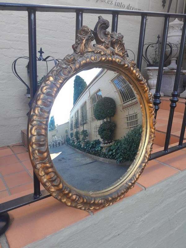 A 20th Century Ornately Carved Gilt Framed Convex Mirror