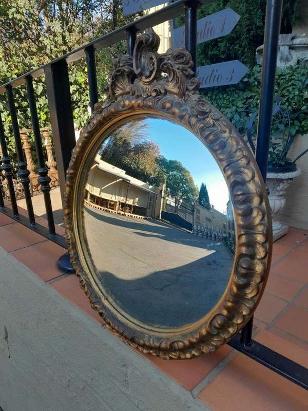 A 20th Century Ornately Carved Gilt Framed Convex Mirror
