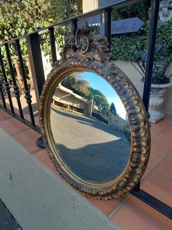 A 20th Century Ornately Carved Gilt Framed Convex Mirror