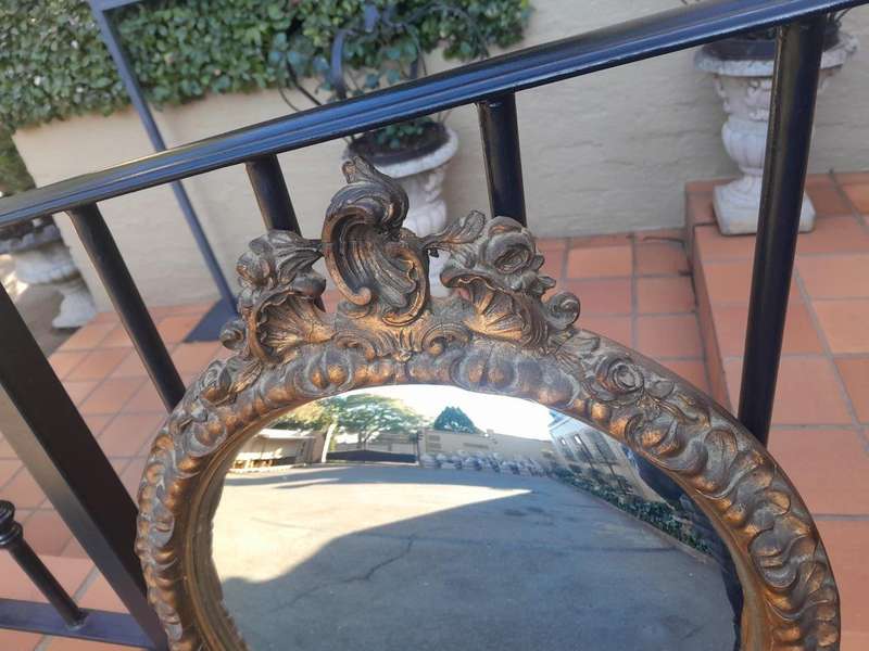A 20th Century Ornately Carved Gilt Framed Convex Mirror
