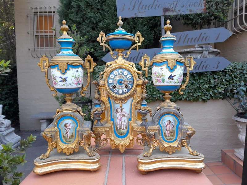 A 19th Century French  Gilt Metal And Porcelain Clock Garniture Set On Original Giltwood Bases A...
