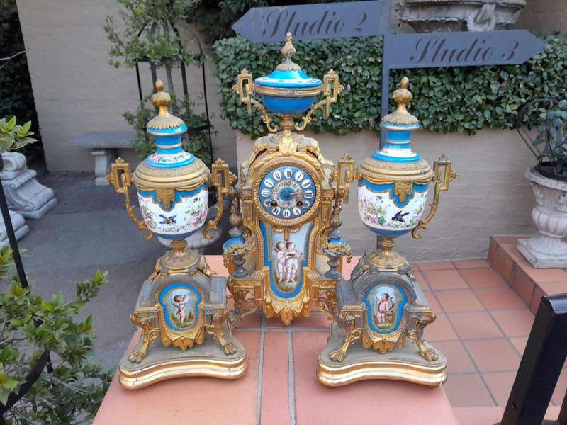 A 19th Century French  Gilt Metal And Porcelain Clock Garniture Set On Original Giltwood Bases A...