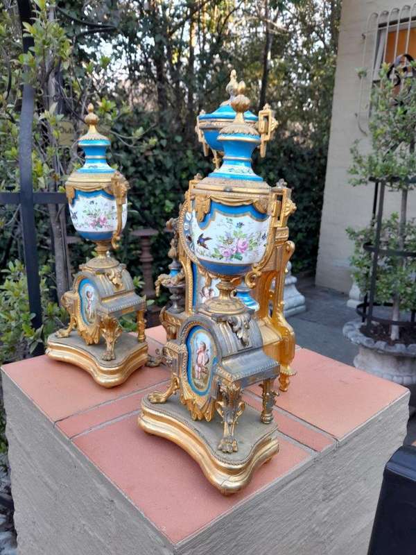 A 19th Century French  Gilt Metal And Porcelain Clock Garniture Set On Original Giltwood Bases A...
