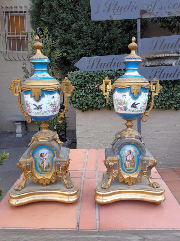 A 19th Century French  Gilt Metal And Porcelain Clock Garniture Set On Original Giltwood Bases A...