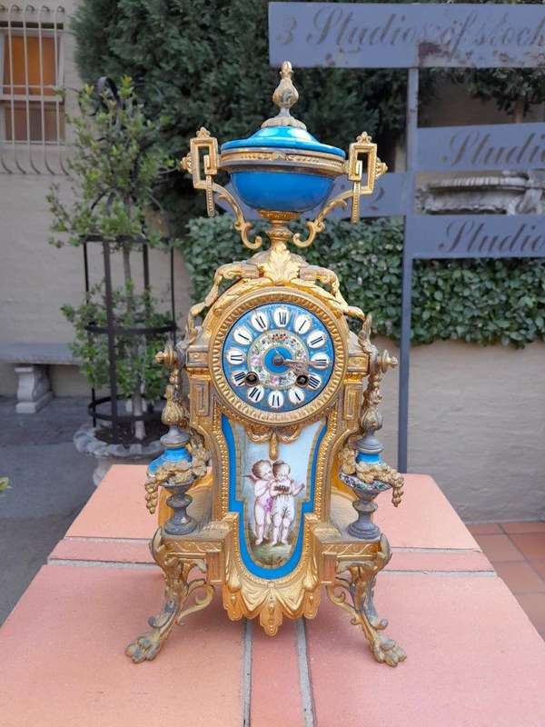 A 19th Century French  Gilt Metal And Porcelain Clock Garniture Set On Original Giltwood Bases A...