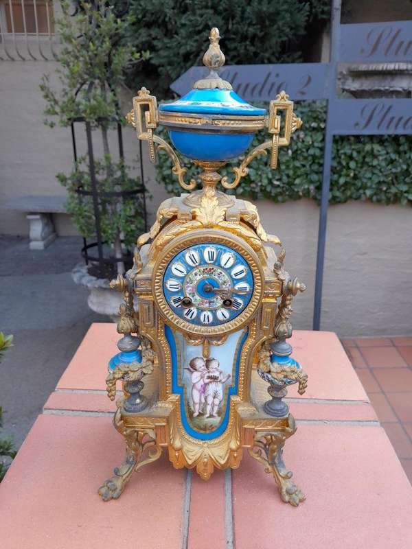 A 19th Century French  Gilt Metal And Porcelain Clock Garniture Set On Original Giltwood Bases A...