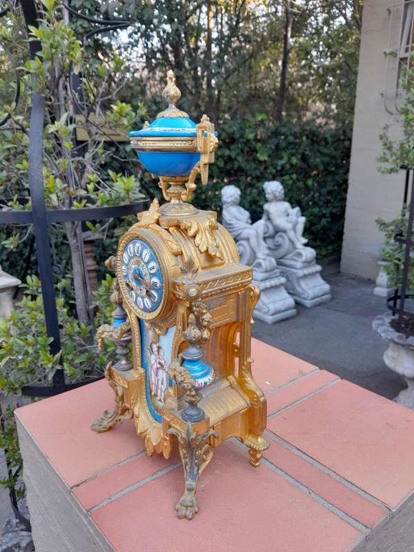 A 19th Century French  Gilt Metal And Porcelain Clock Garniture Set On Original Giltwood Bases A...