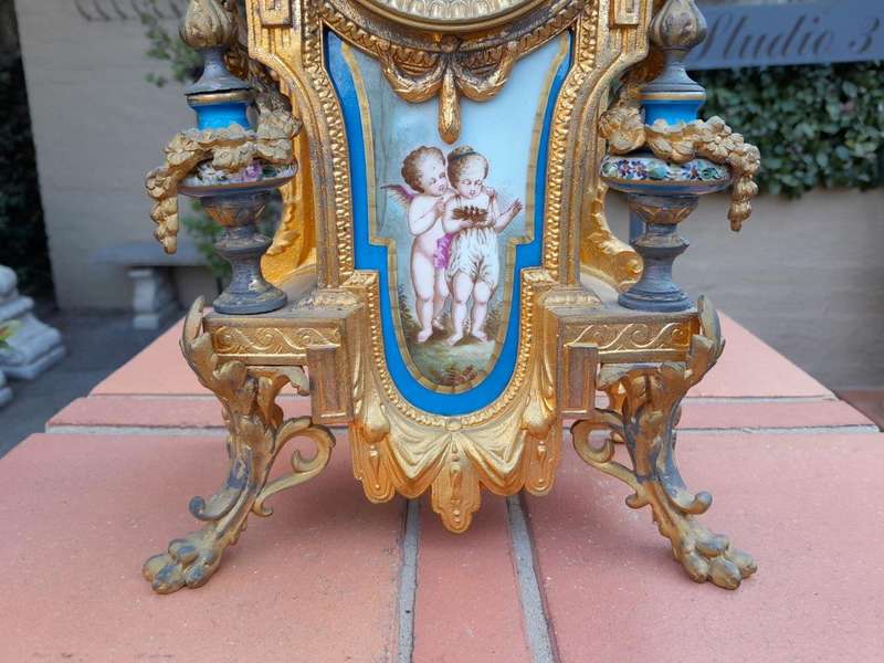 A 19th Century French  Gilt Metal And Porcelain Clock Garniture Set On Original Giltwood Bases A...
