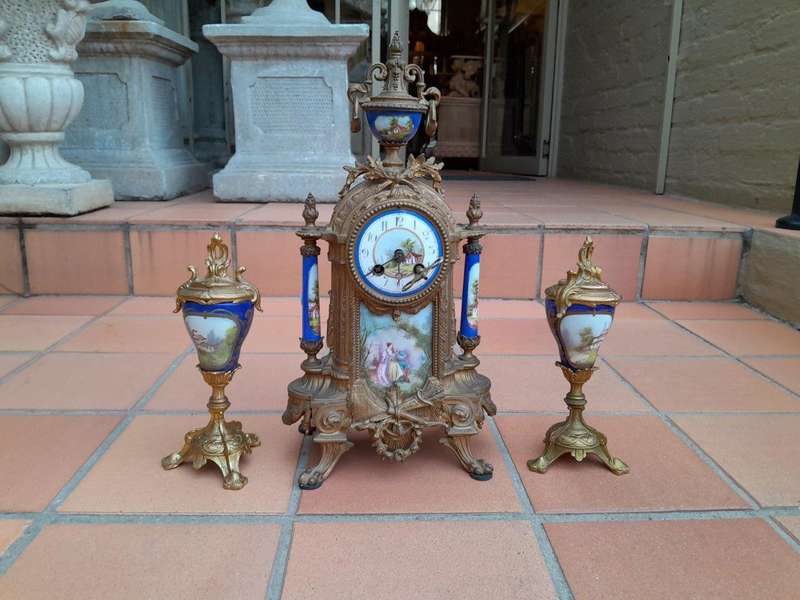 A 19th Century French Garniture Set With Gilt Bonze Clock With Key  And Pair Of Gilt Metal Porce...