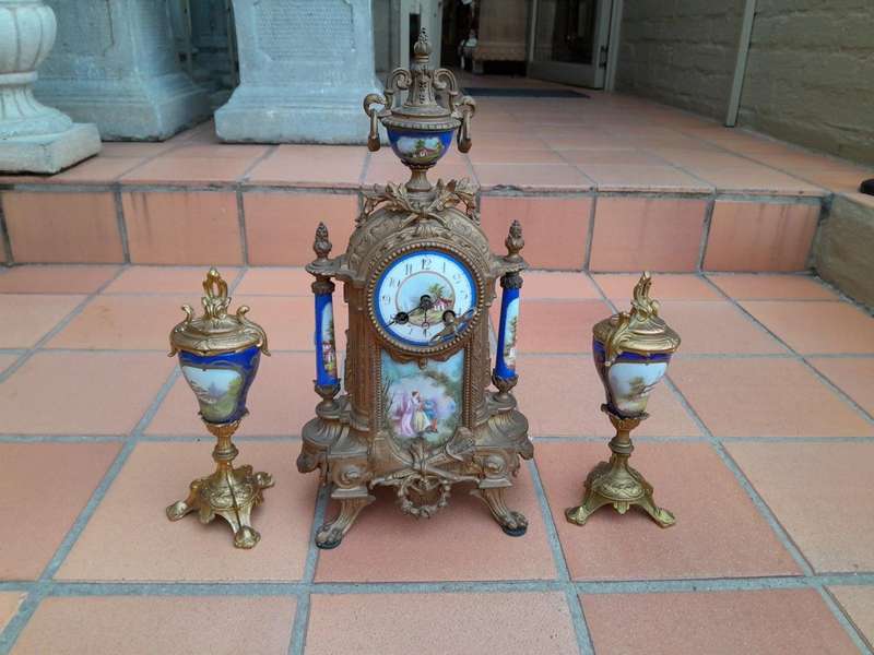 A 19th Century French Garniture Set With Gilt Bonze Clock With Key  And Pair Of Gilt Metal Porce...