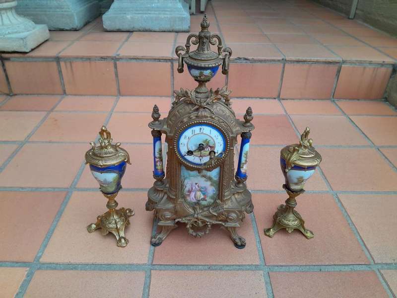 A 19th Century French Garniture Set With Gilt Bonze Clock With Key  And Pair Of Gilt Metal Porce...