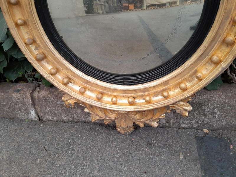 An  English Antique 19th Century Circa 1830s Regency Convex Mirror with Eagle and Ball Detail