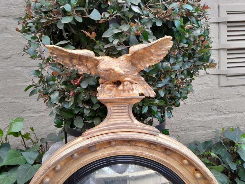 An  English Antique 19th Century Circa 1830s Regency Convex Mirror with Eagle and Ball Detail