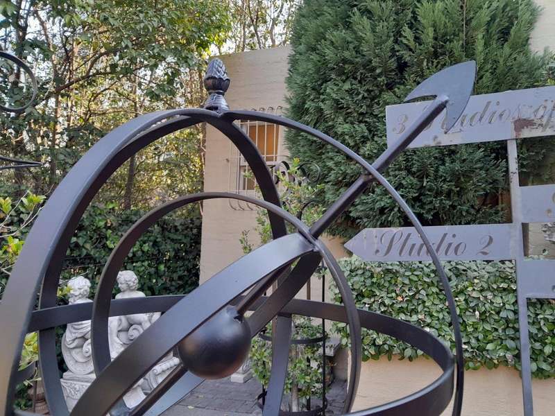 A Decorative Wrought Iron Armillary Sphere in a  Black Finish