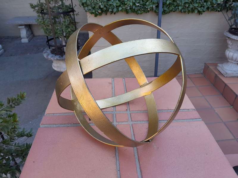 A Decorative Wrought Iron Ball in a Hand Gilded with Gold Leaf Finish (Small)