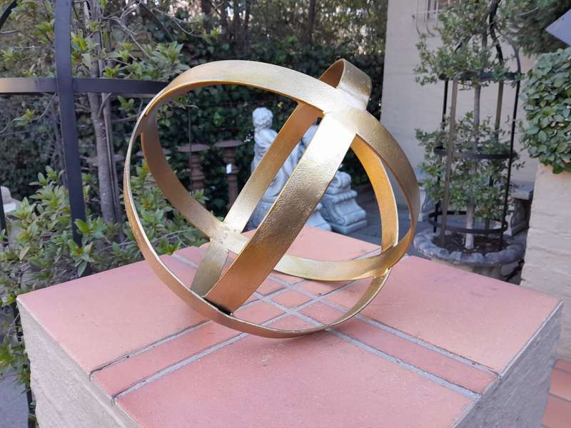 A Decorative Wrought Iron Ball in a Hand Gilded with Gold Leaf Finish (Small)