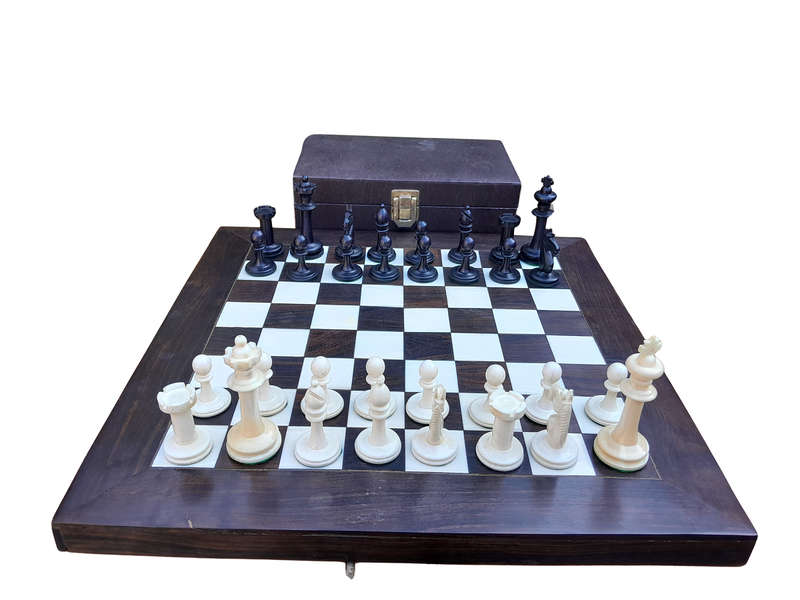 A 20th Century Hand Carved Ebony And Ivory Chess Set With Board And Leather Case