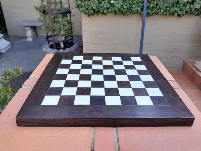 A 20th Century Hand Carved Ebony And Ivory Chess Set With Board And Leather Case