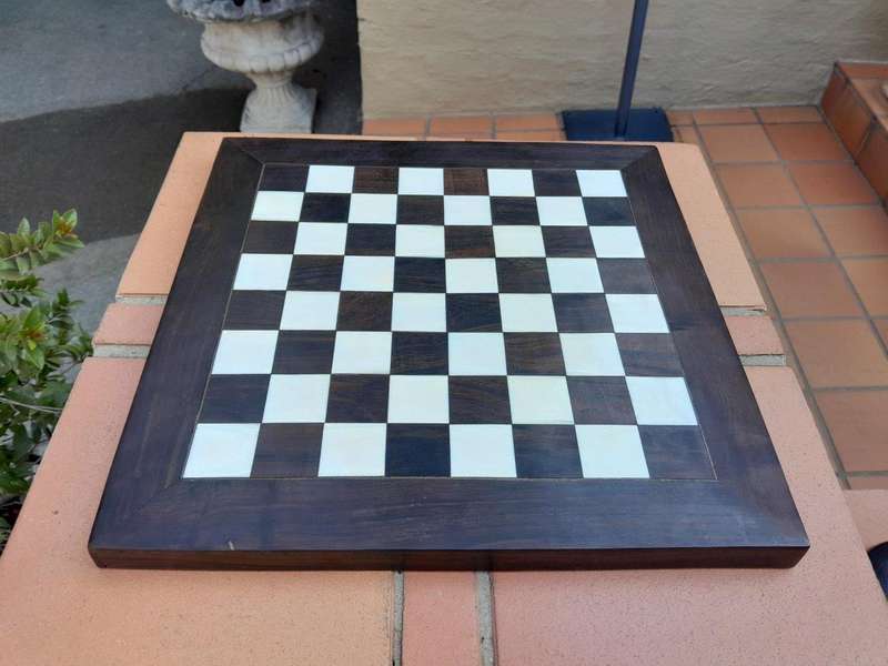 A 20th Century Hand Carved Ebony And Ivory Chess Set With Board And Leather Case