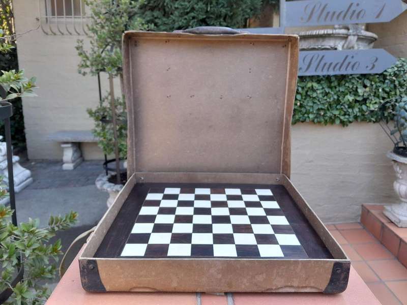 A 20th Century Hand Carved Ebony And Ivory Chess Set With Board And Leather Case