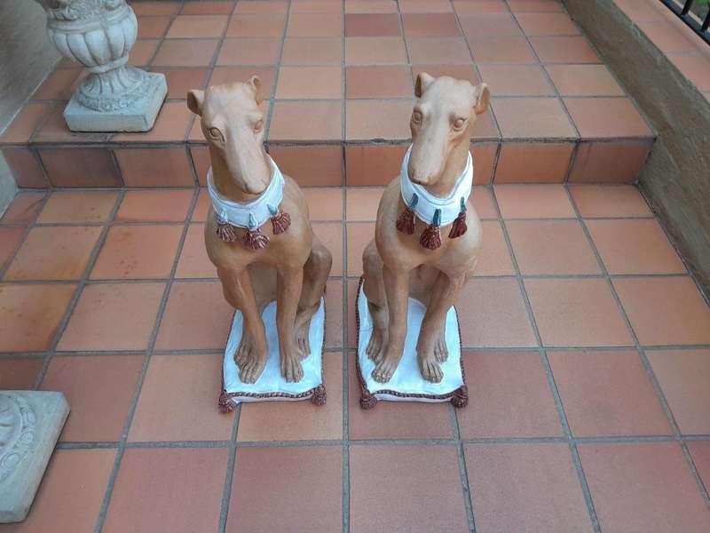 A 20th Century Pair Of Ceramic Whippets On Cushion Bases