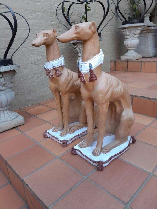 A 20th Century Pair Of Ceramic Whippets On Cushion Bases