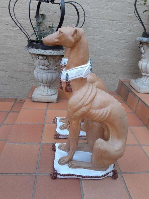 A 20th Century Pair Of Ceramic Whippets On Cushion Bases