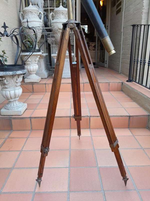 An Antique Brass And Leather Telescope On Brass And Oak Tripod Stand