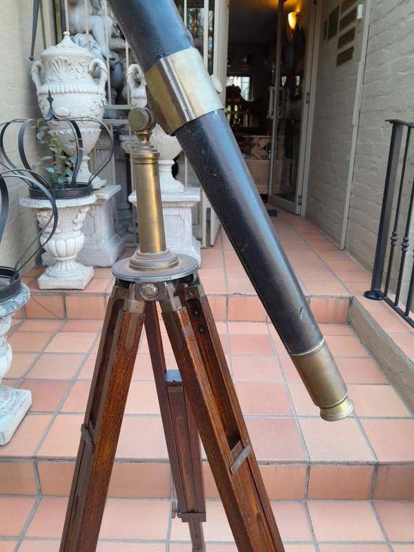 An Antique Brass And Leather Telescope On Brass And Oak Tripod Stand