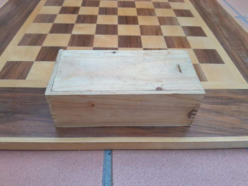A Wooden Chess Set Comprising Chess Pieces And A Chess Board