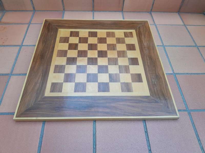 A Wooden Chess Set Comprising Chess Pieces And A Chess Board