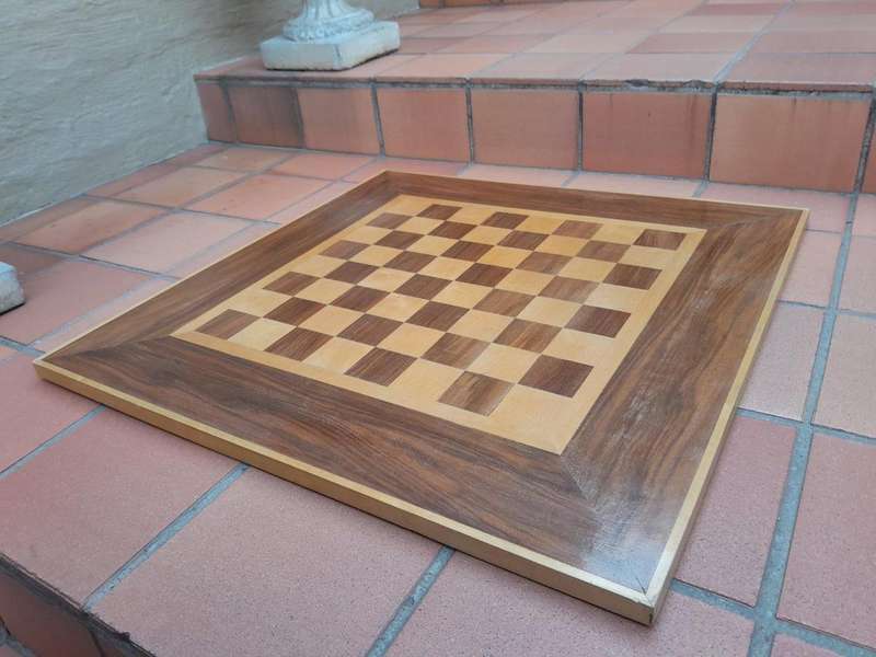 A Wooden Chess Set Comprising Chess Pieces And A Chess Board