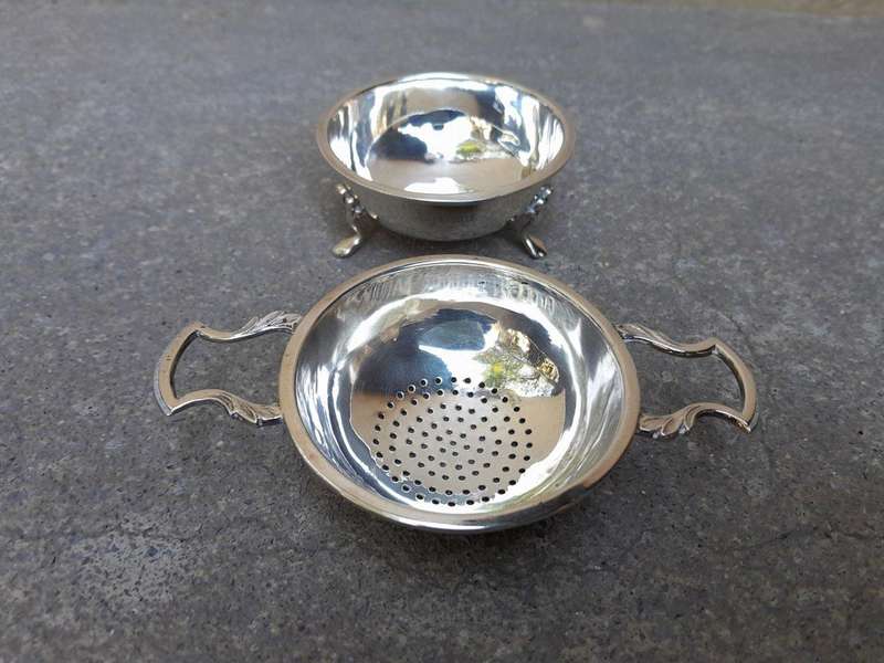 An English Elizabeth II Circa 1956 Georgian-style  Silver Tea Strainer  on Feet  Dimensions: ...
